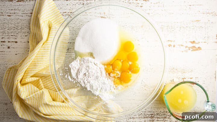 A selection of ingredients for the lemon tart filling, including sugar, flour, cornstarch, salt, and eggs, arranged in mixing bowls.