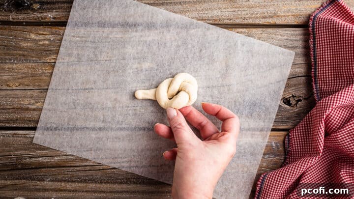 Tucking first end of garlic knot under.