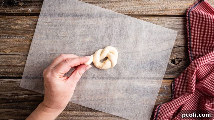 Tucking second end of garlic knot under.