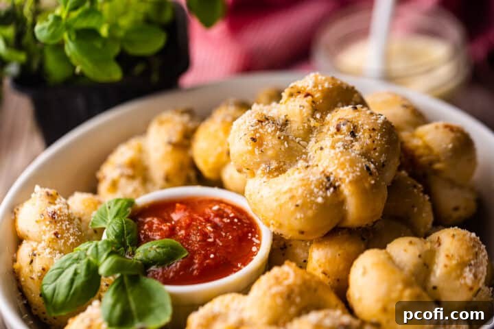 How to make garlic knots with herb garlic butter and ground parmesan.