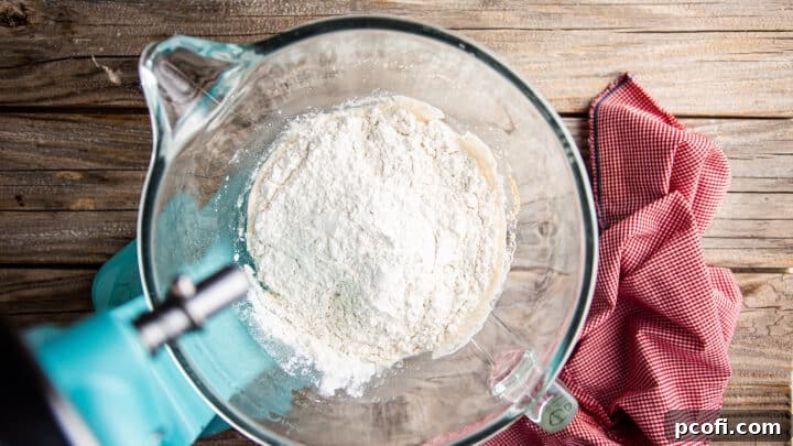 Adding flour to make dough for garlic knots.