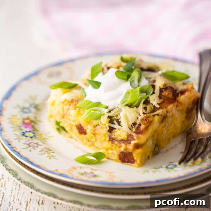 Slice of breakfast casserole on a vintage plate with a pink checked cloth.