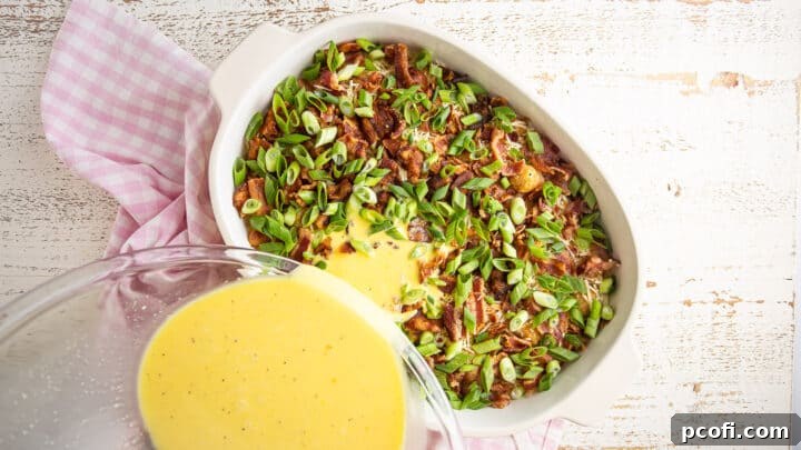 Pouring egg mixture into breakfast casserole.