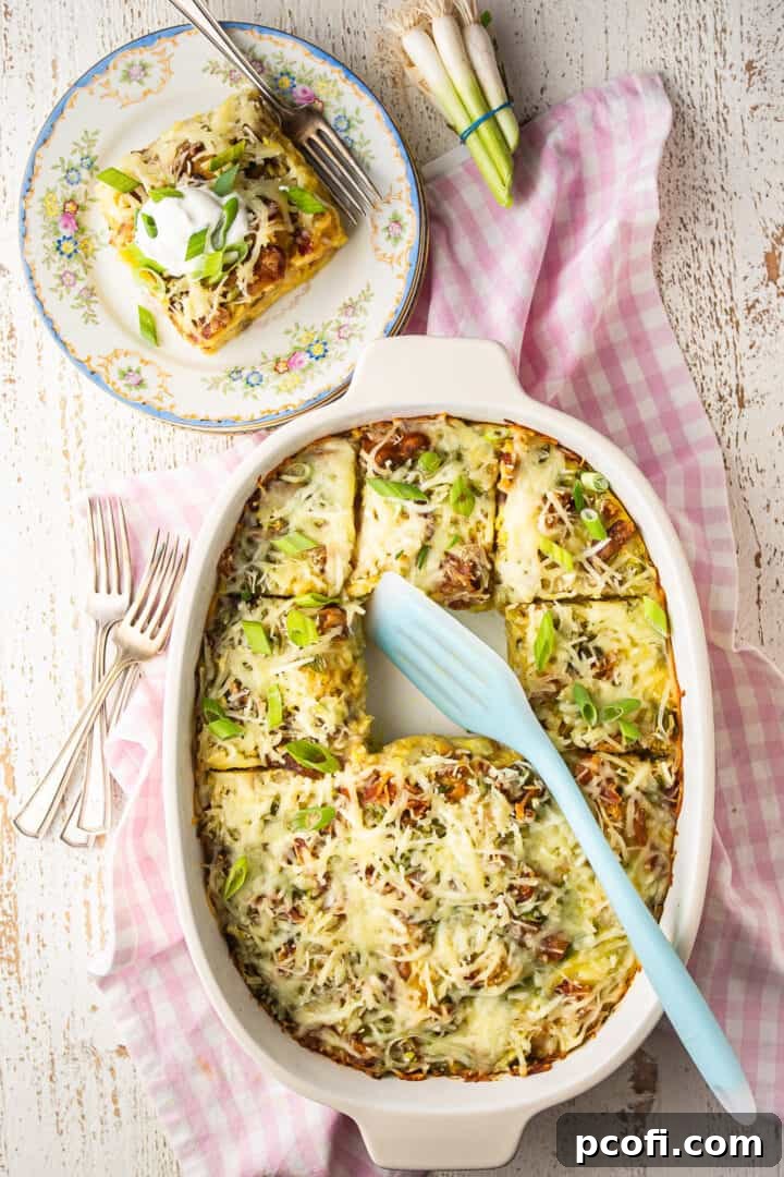 Overhead image of tater tot breakfast casserole in a baking dish with scallions.