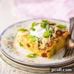 Slice of breakfast casserole on a vintage plate with a pink checked cloth.