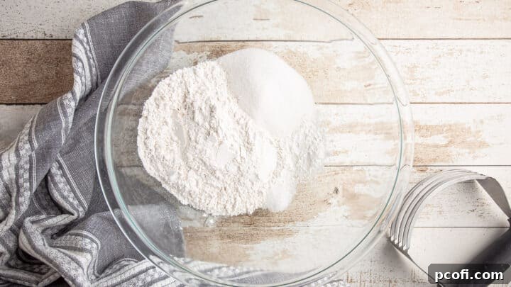 Dry ingredients for chocolate chip scones in a large glass mixing bowl, ready for mixing.