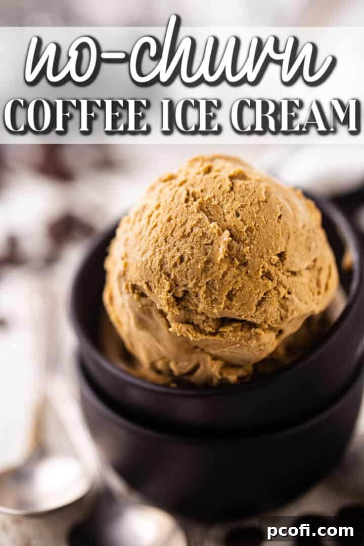 Two scoops of homemade coffee ice cream served in a small clear bowl with vintage silver spoons, ready to be enjoyed.