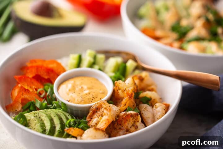 What to serve with bang bang shrimp in a white bowl with a copper fork.