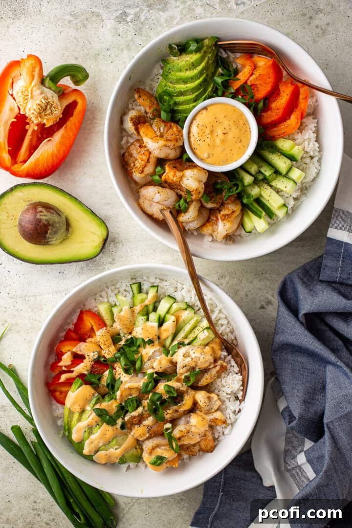 Bang bang shrimp recipes prepared in bowls with fresh vegetables.