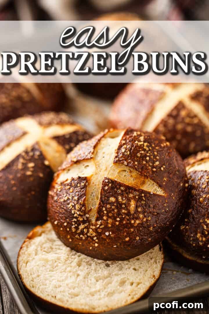 A baking tray filled with golden-brown homemade pretzel buns, with a text overlay reading "Easy Pretzel Buns."