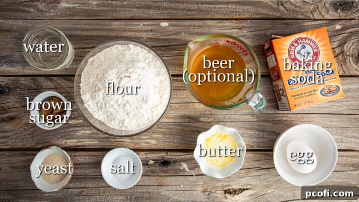 Various ingredients for making pretzel buns, including flour, sugar, yeast, and butter, clearly labeled on a surface.