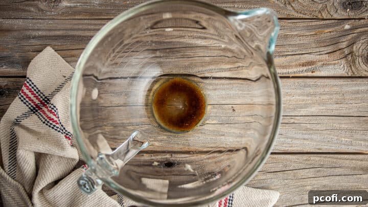 Brown sugar dissolving in warm water, the first step in making pretzel buns.