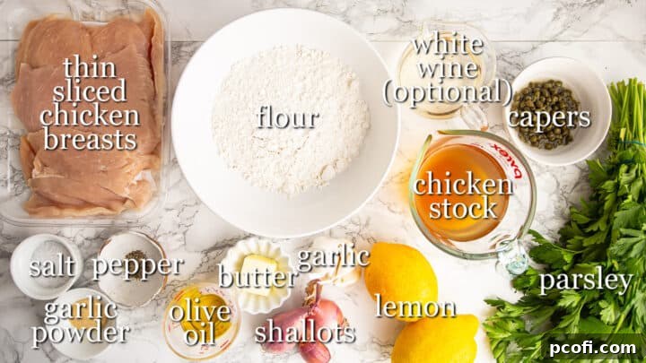 A selection of fresh ingredients laid out for making chicken piccata, including chicken, lemon, capers, shallots, garlic, butter, and olive oil.