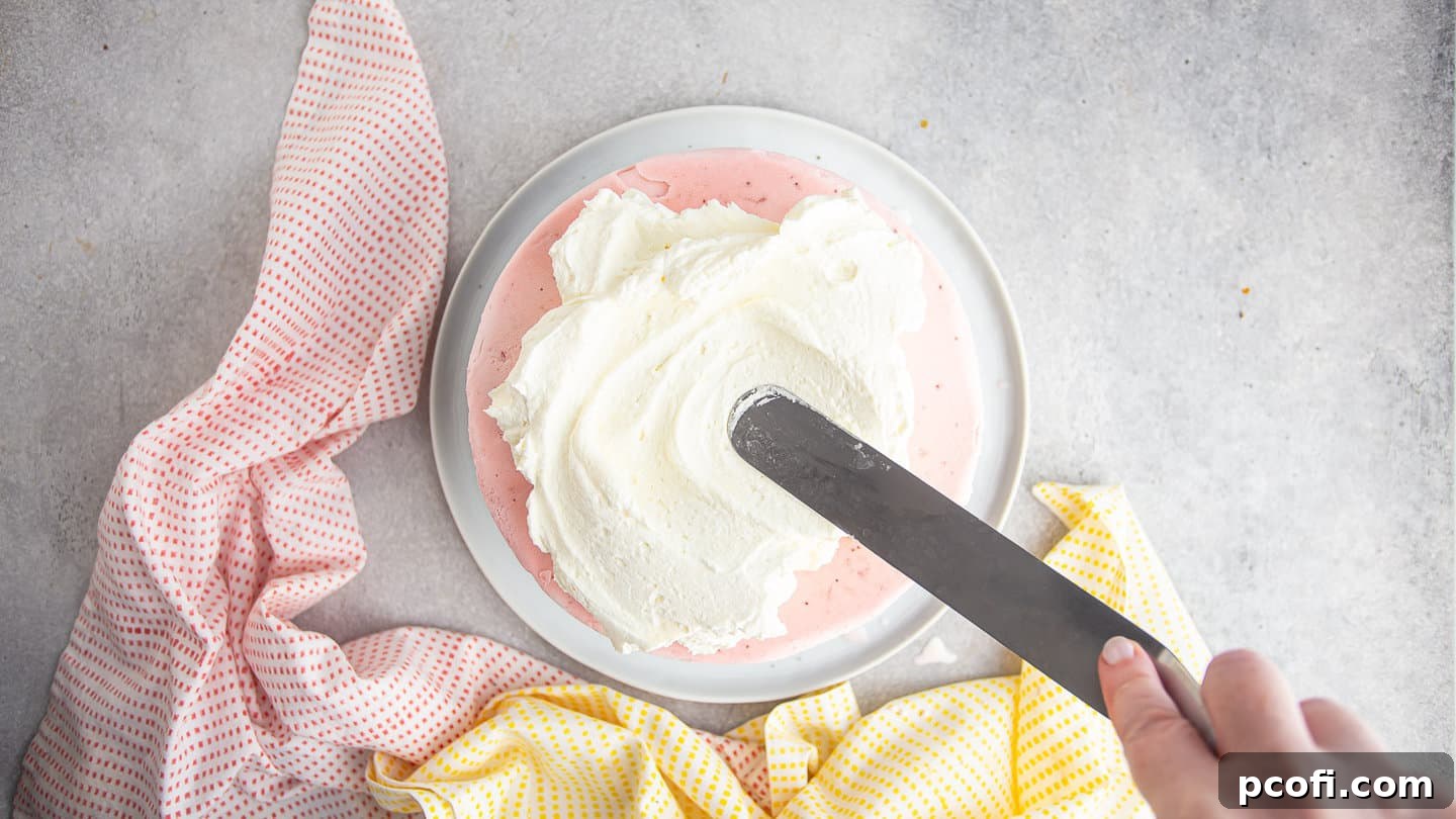 Frosting ice cream cake with whipped cream icing.