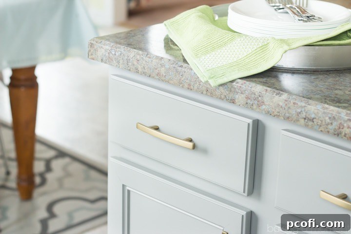 Stylized shot of a modern kitchen with grey lower cabinets and white uppers