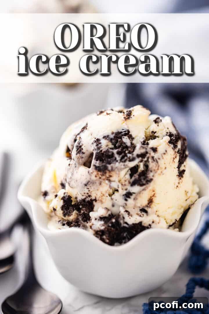 Cookies and cream ice cream scooped into a ruffled white porcelain bowl, garnished with more cookie pieces.