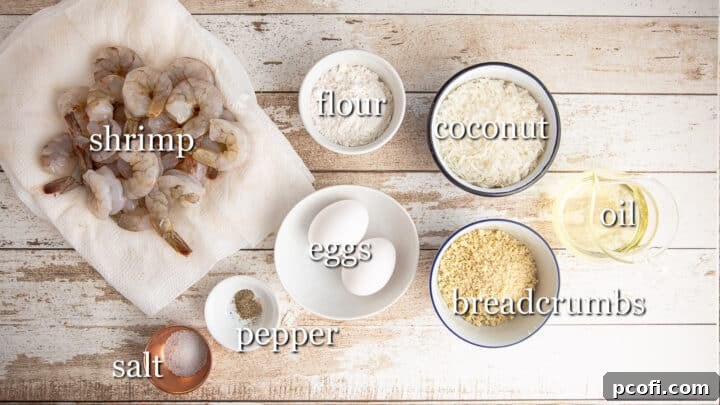 A selection of ingredients for making coconut shrimp, clearly labeled for easy identification.