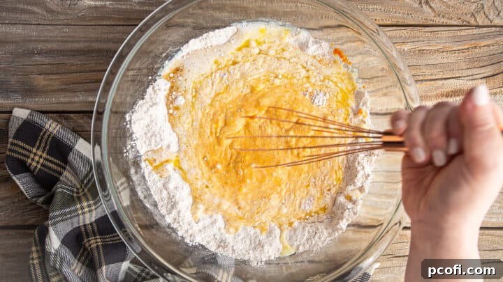 Whisking pumpkin pancake batter.