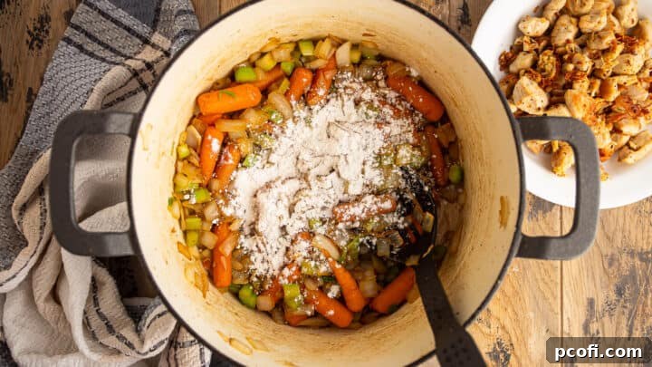 Sprinkling cooked vegetables with flour to make a roux.