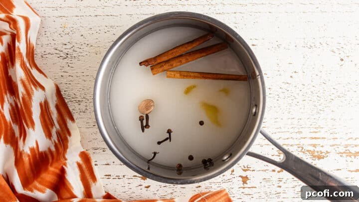 Sugar, water, and whole spices in a small pot.