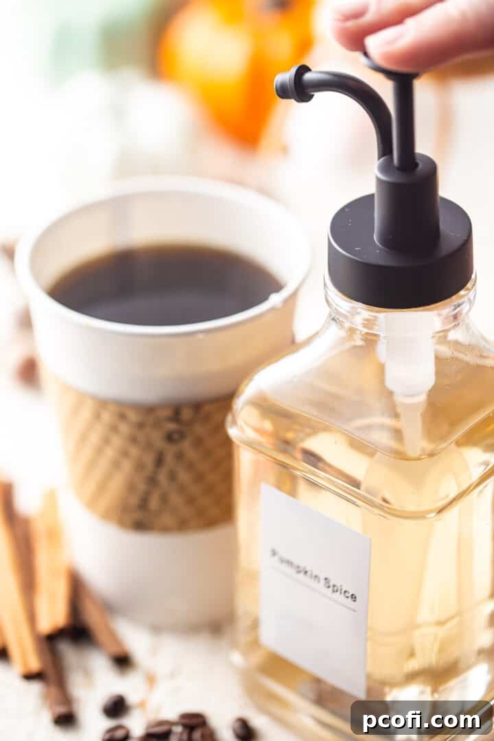 Pumpkin pumpkin spice coffee syrup into a to-go cup of black coffee.