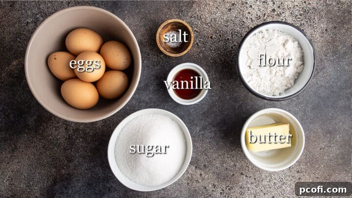 All the essential ingredients for Genoise cake laid out on a clean surface, with labels for easy identification.