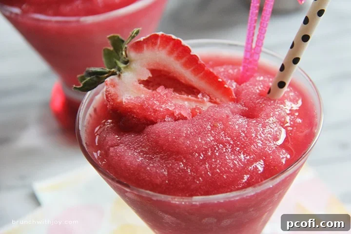 Refreshing Strawberry Moscato Slush in a glass, perfect for cooling down on a hot summer day.