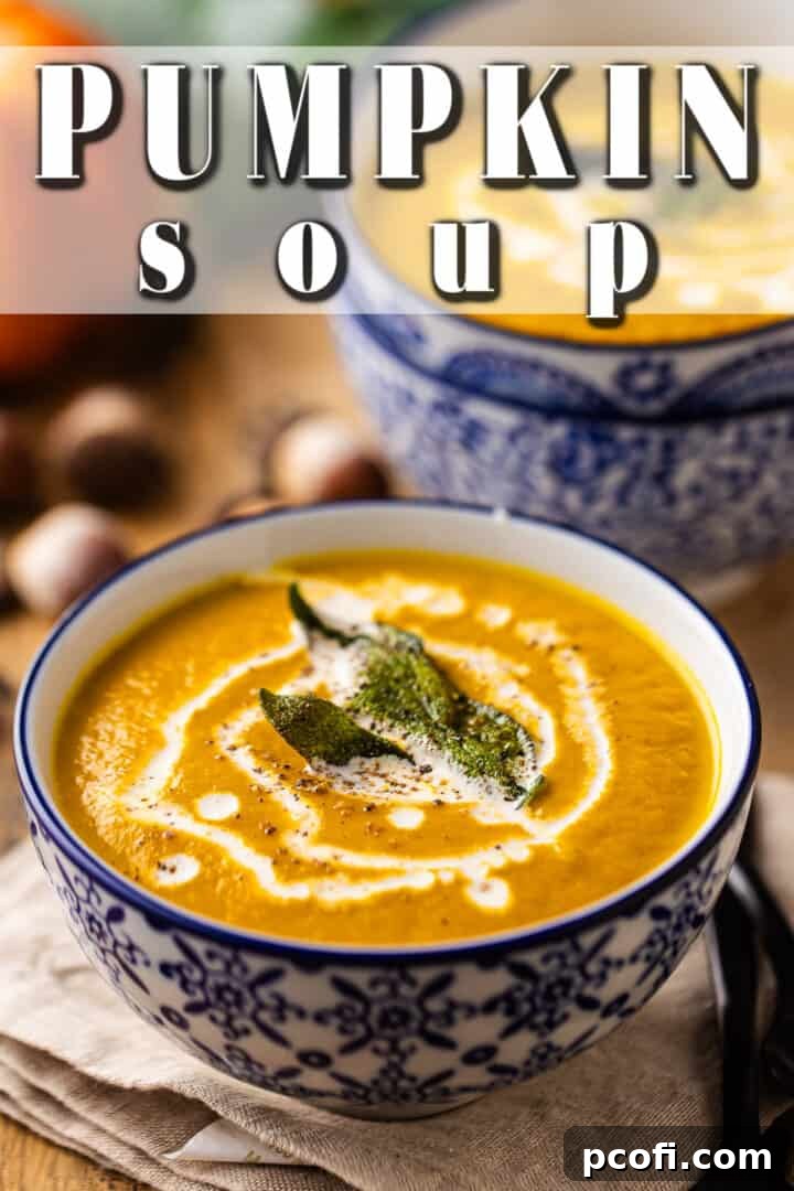 Rich pumpkin soup enhanced with browned sage butter and a drizzle of heavy cream, offering a luxurious texture.
