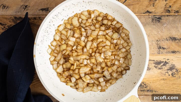 Chopped onions gently sautéing in fragrant sage brown butter, turning translucent to form the soup's aromatic base.