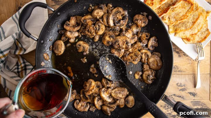 Slowly whisking marsala wine into mushrooms, shallots, and roux.