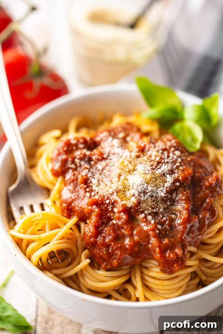 Homemade tomato sauce, served over cooked spaghetti with fresh basil and parmesan cheese.