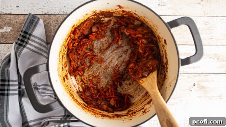 Removing fond from the bottom of the pot by deglazing with balsamic vinegar.