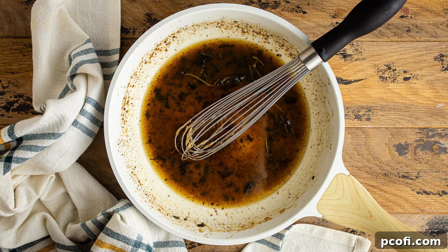 Making maple and sage brown butter turkey glaze in a light colored skillet.