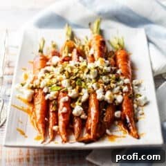 Glazed carrots on a rectangular white serving platter.