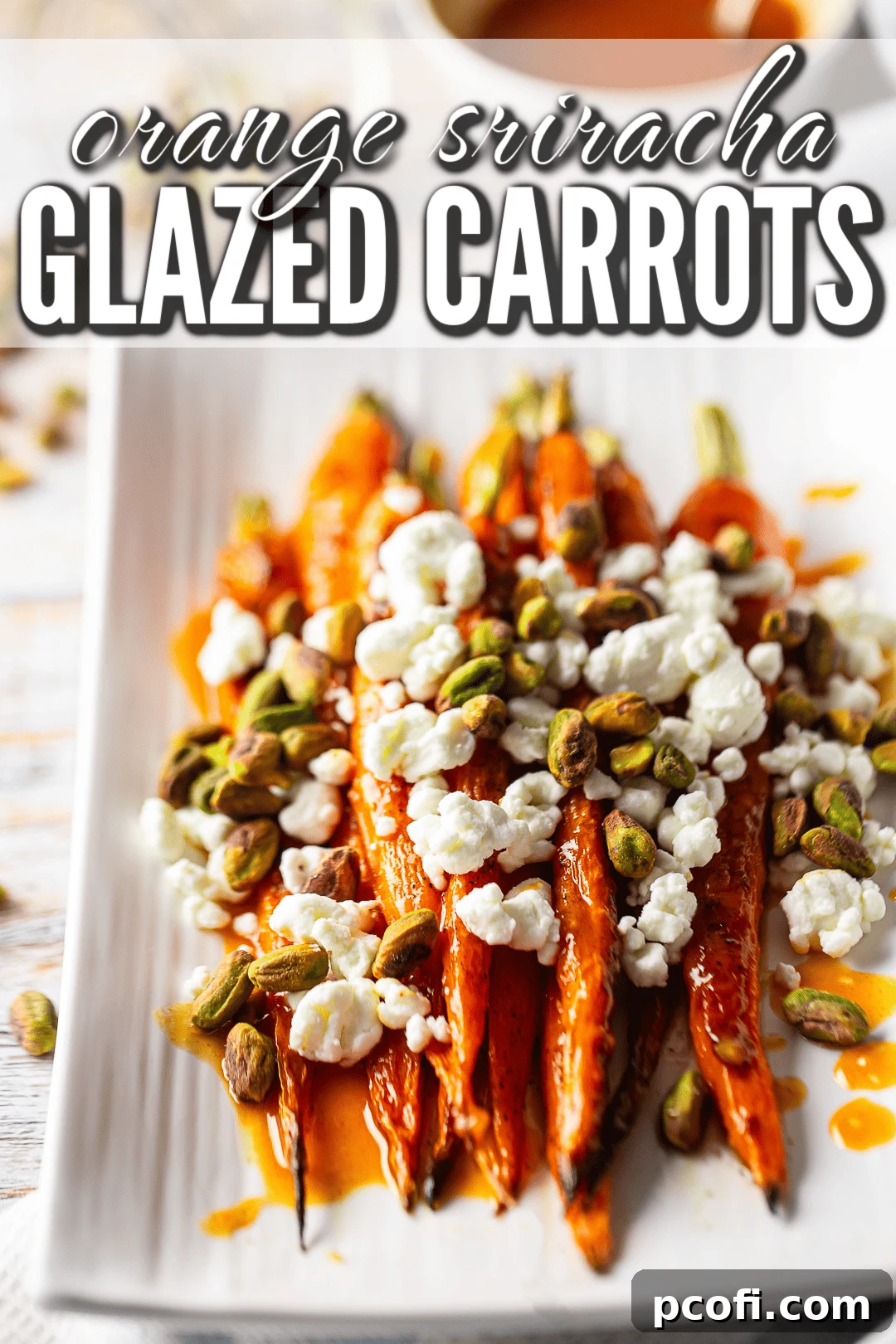Glazed carrots recipe prepared and garnished with goat cheese and toasted pistachios, ready to serve.