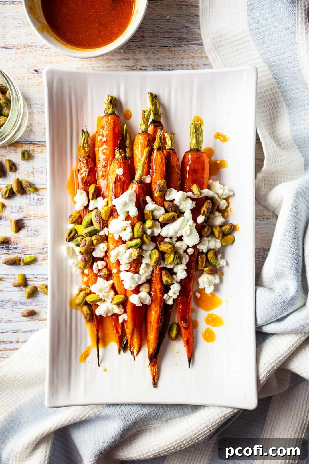 Glazed carrot recipes with orange, goat cheese, and nuts, showcasing the delicious plating.