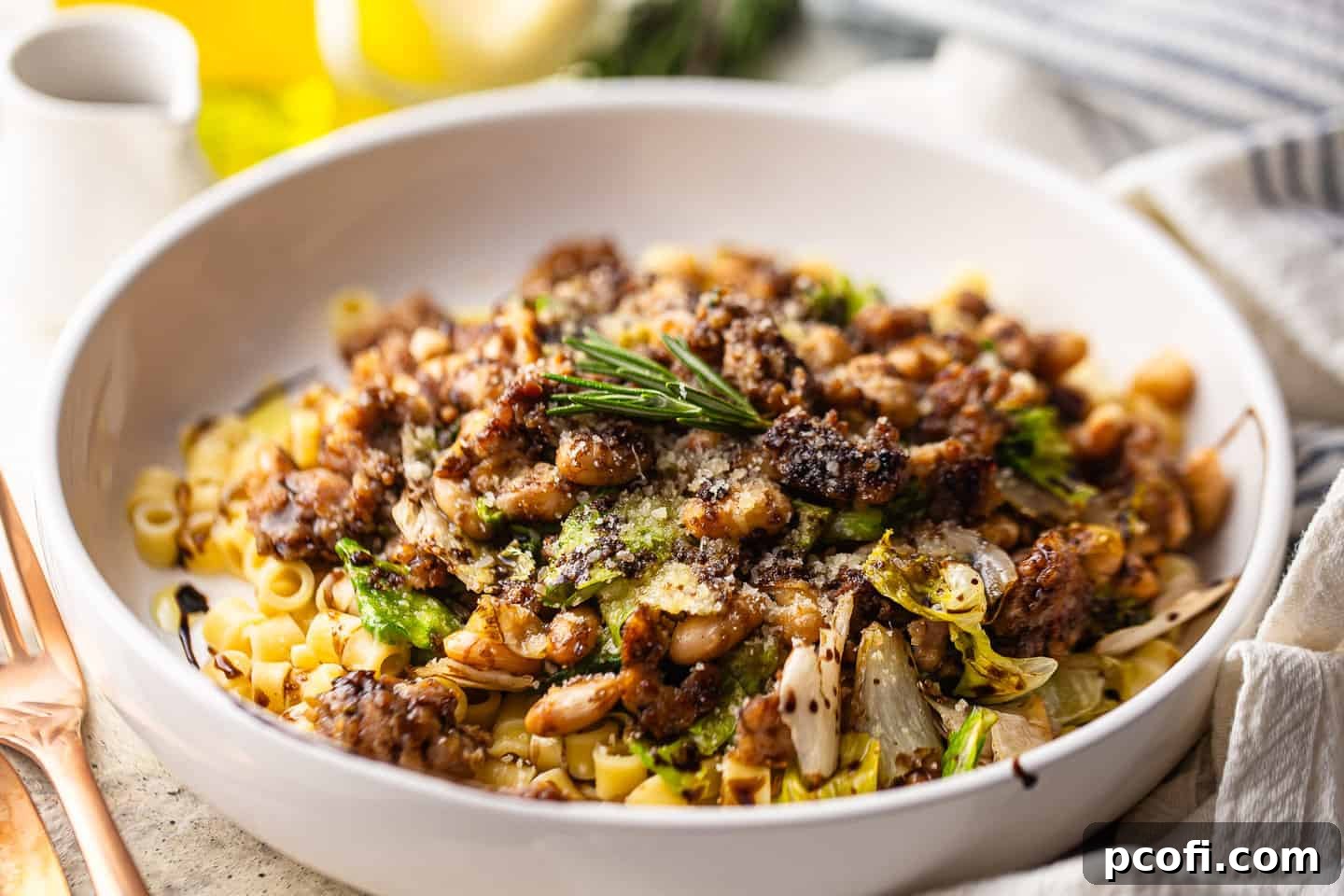A beautifully presented bowl of white beans with escarole and Italian sausage, ready to be enjoyed.