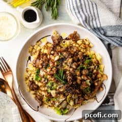 White beans and greens in a bowl with sweet Italian sausage and ditalini pasta.