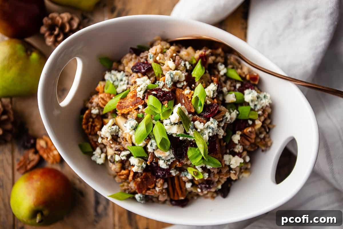 A generously sized white serving bowl filled with gourmet wild rice stuffing, accompanied by a large serving spoon.