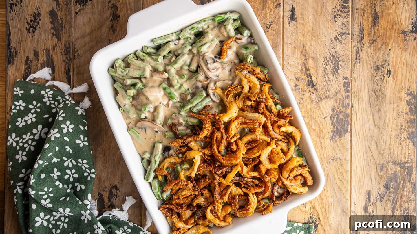 Layering homemade French-fried onions over green bean casserole.