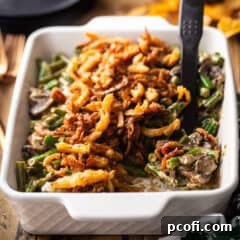 Homemade green bean casserole recipe, baked in a casserole dish and topped with French fried onions.