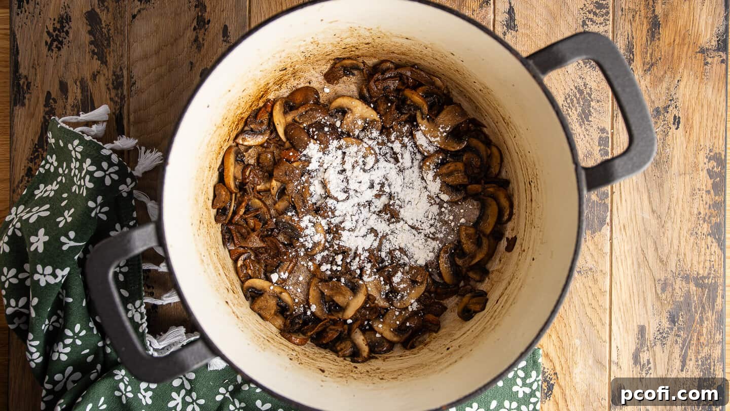 Sprinkling flour on cooked mushrooms to make a roux.