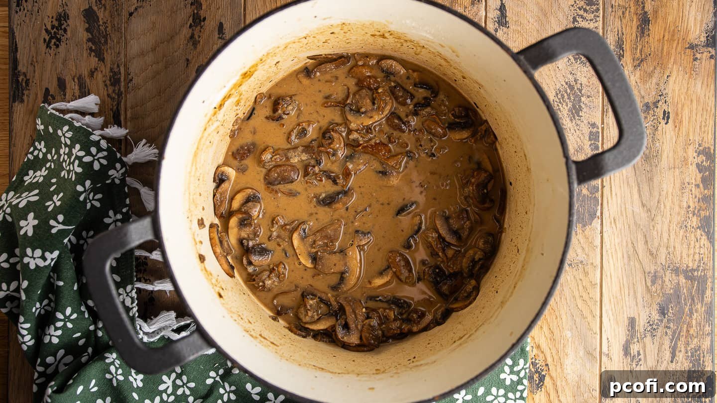 Adding mushroom liquid to make a thick gravy.