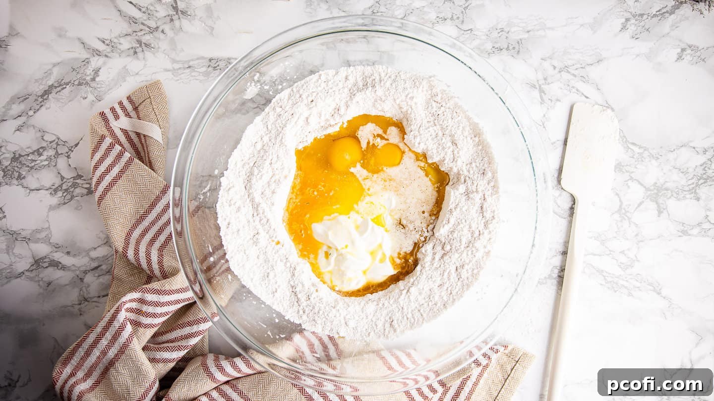 Liquid ingredients carefully added into the well of dry ingredients, ready for gentle mixing to form the muffin batter.