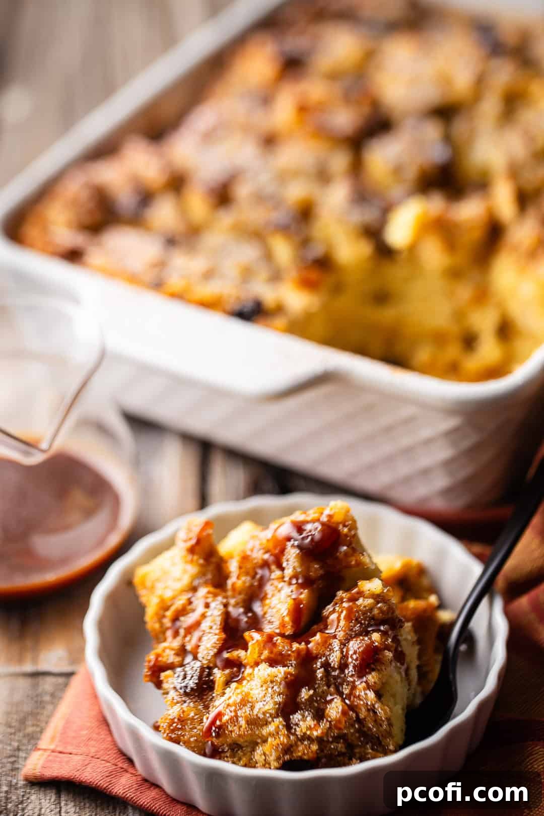 Bread pudding in a dish on a wooden background.