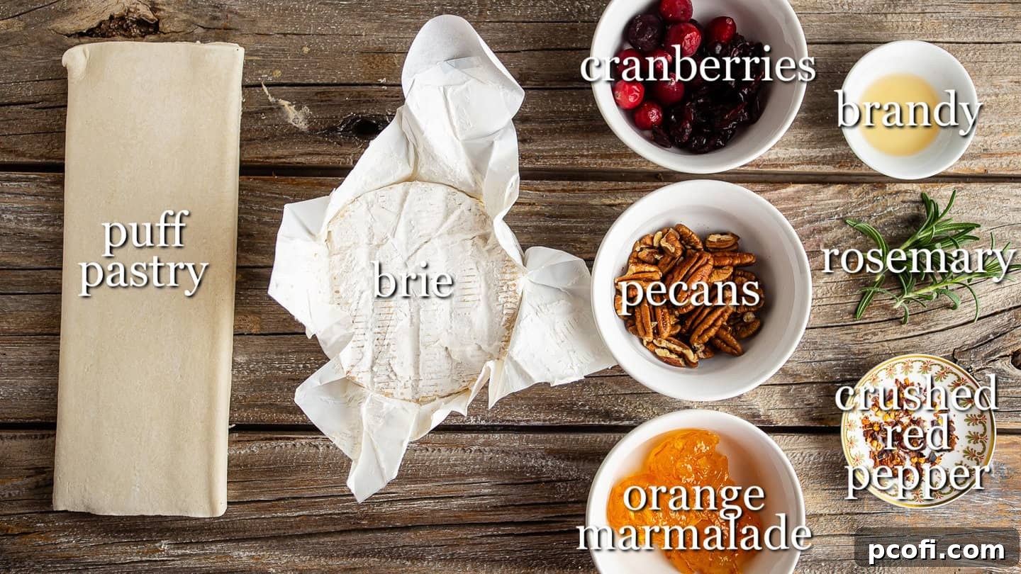 Ingredients for making baked brie in puff pastry, with text labels illustrating each component.