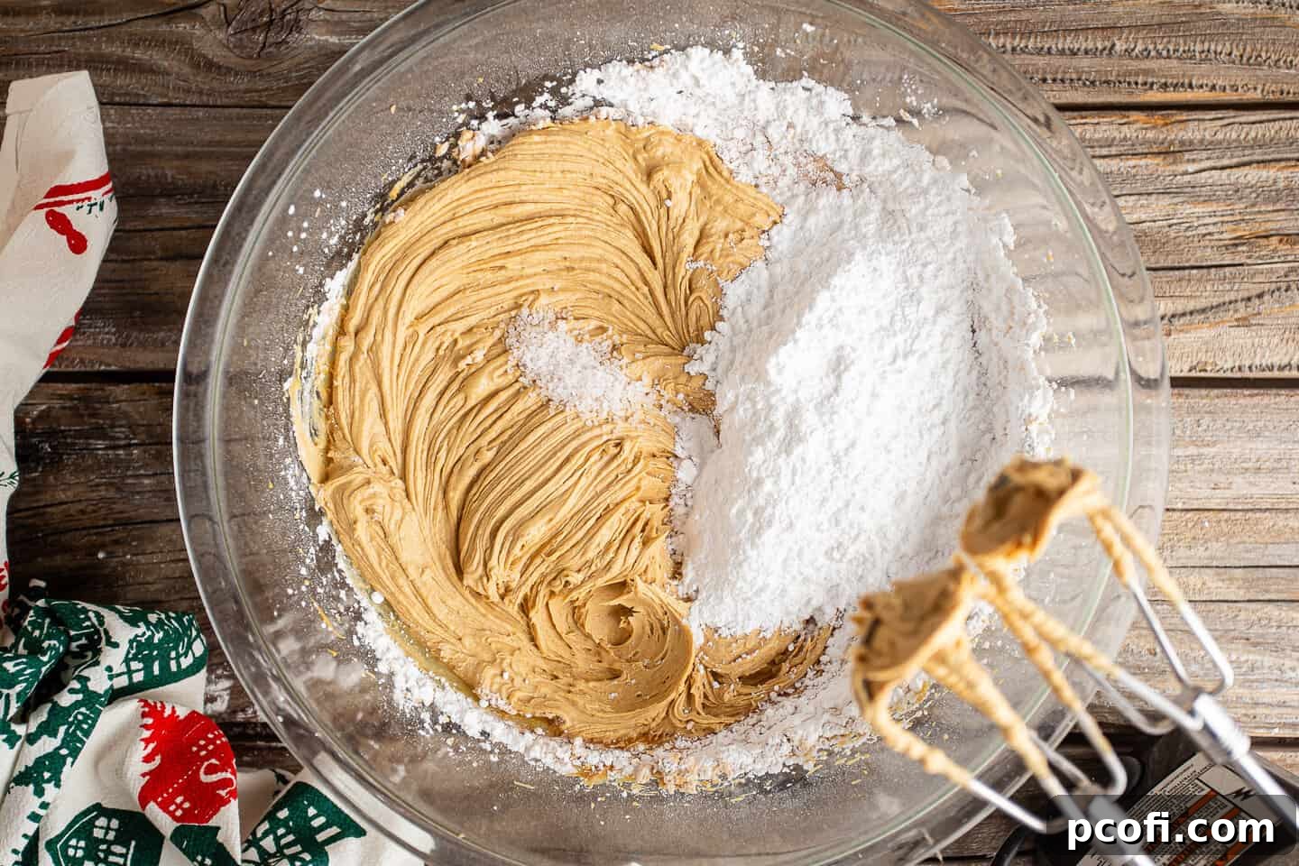 Adding powdered sugar to buckeye recipe.