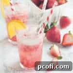 Strawberry Orange Blossom Sparkler in a glass with a garnish.