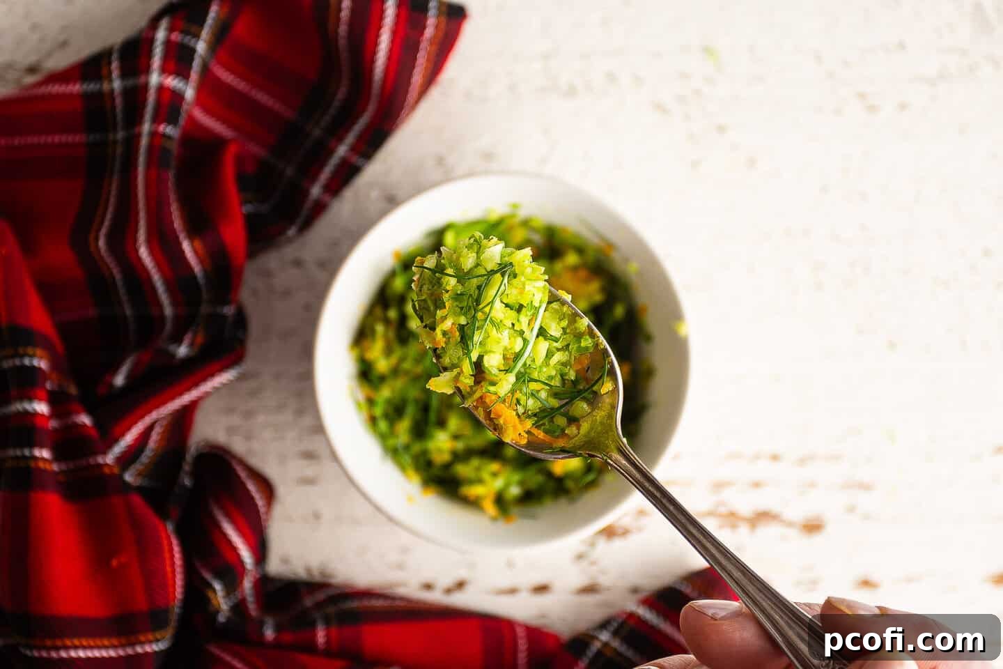 Fennel orange gremolata, presented on a vintage silver spoon.