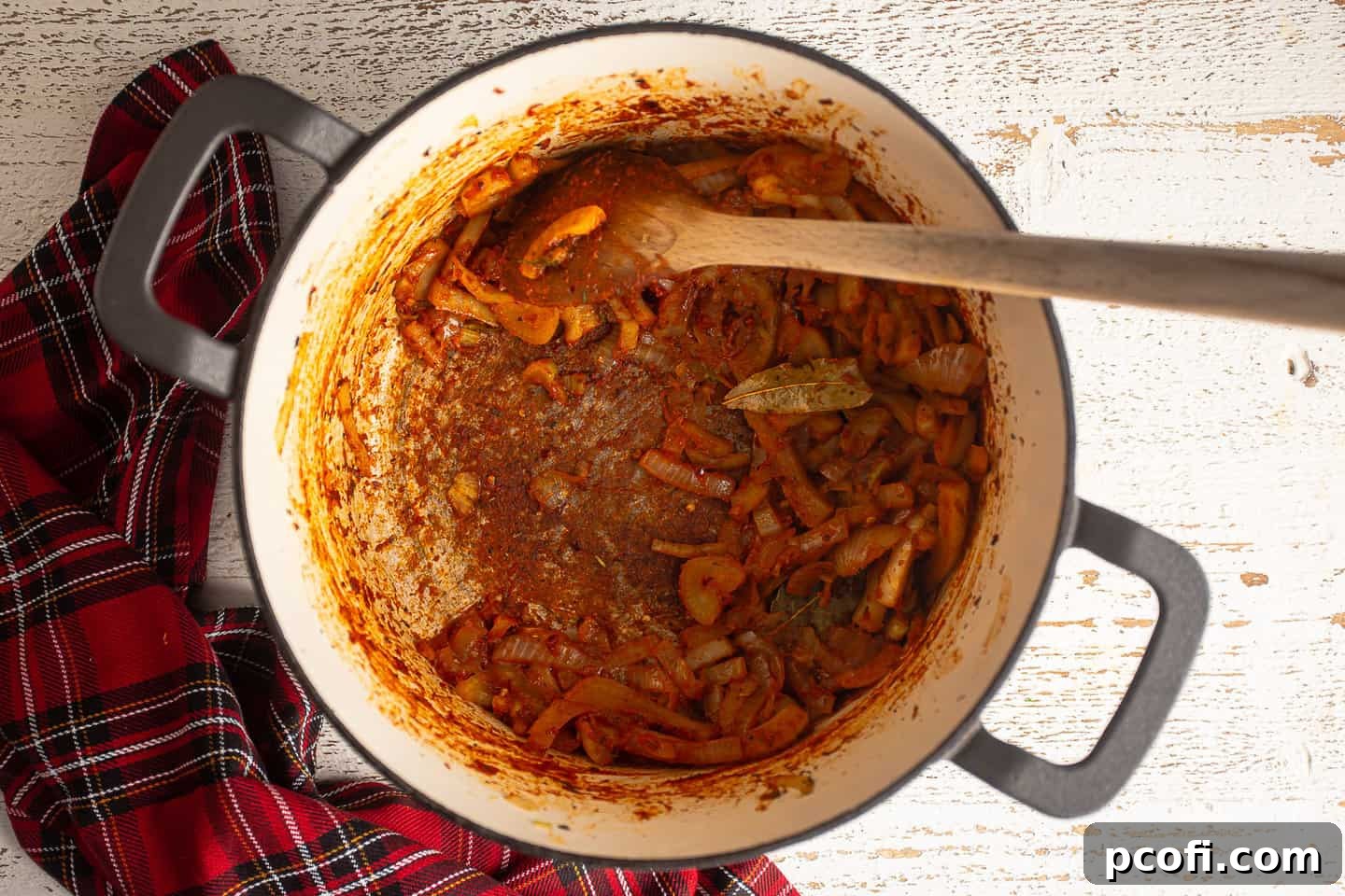 Browning tomato paste to create fond on the bottom of the pot.